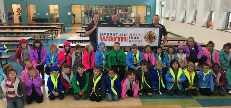 A group picture showing members of the Morgantown Professional Firefighters IAFF Local 313 with chil