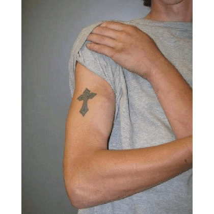 A picture of a cross tattoo on Dylan Yoders upper right arm.