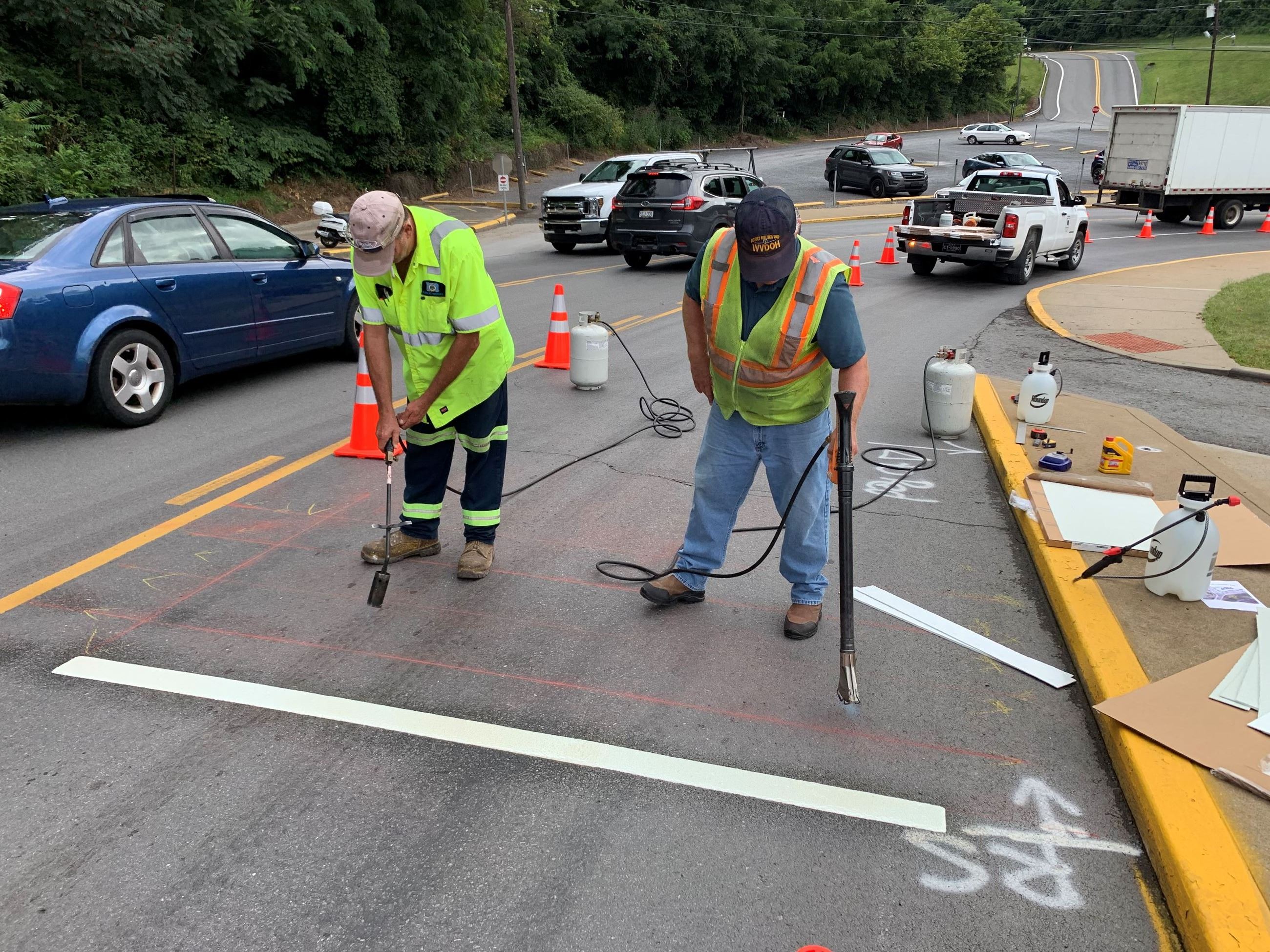A picture of Morgantown Public Works and WVDOH crews installing rumble strips on University Avenue.